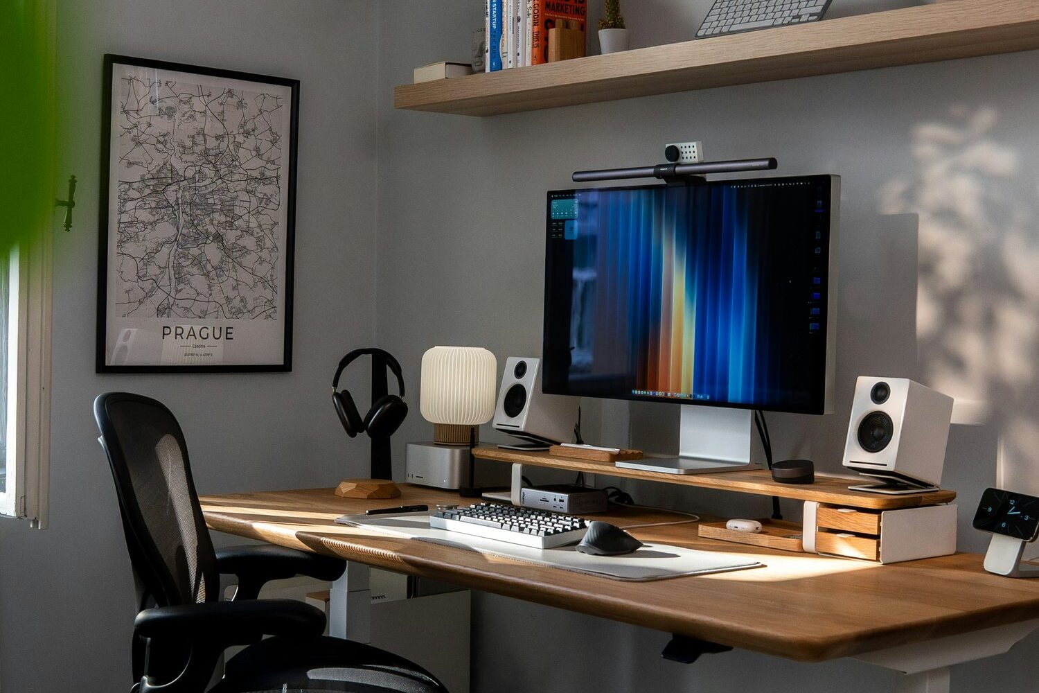 A desk with a laptop, notebook and phone