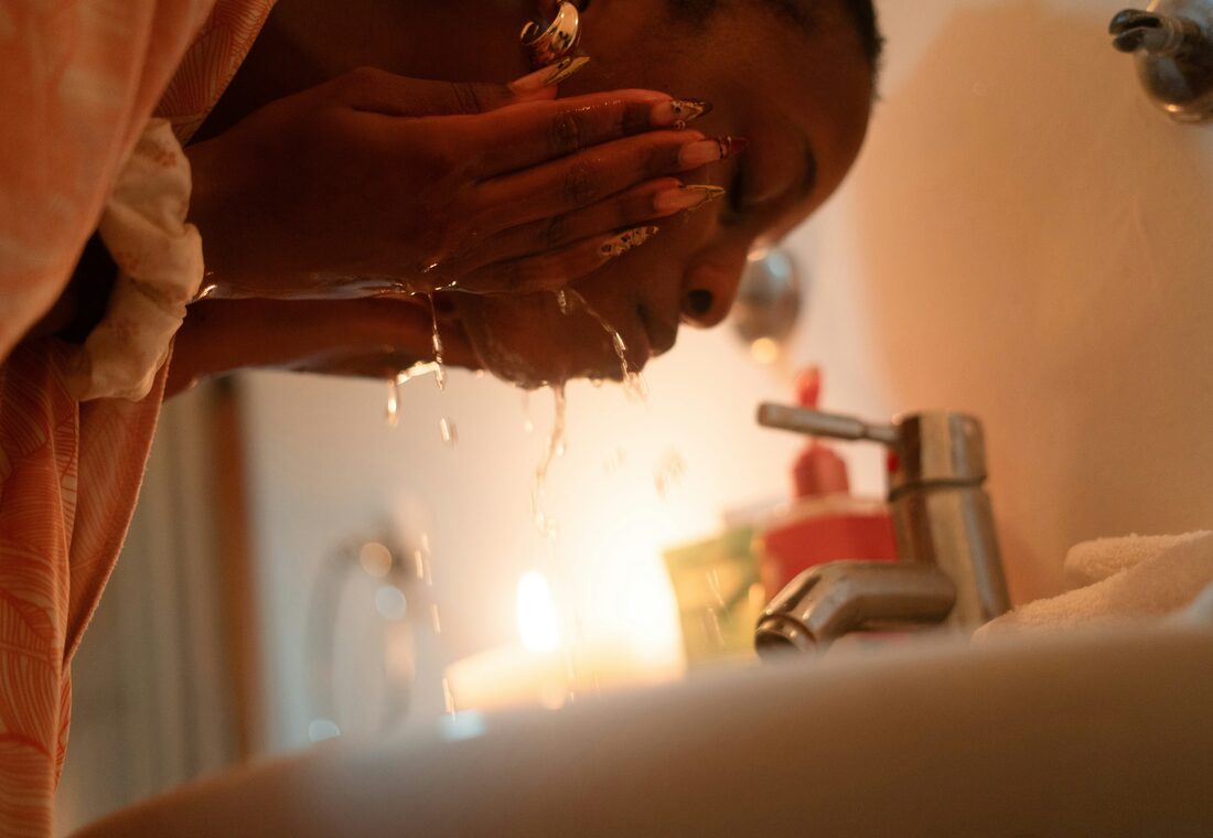 A personal care product in use at a bathroom sink