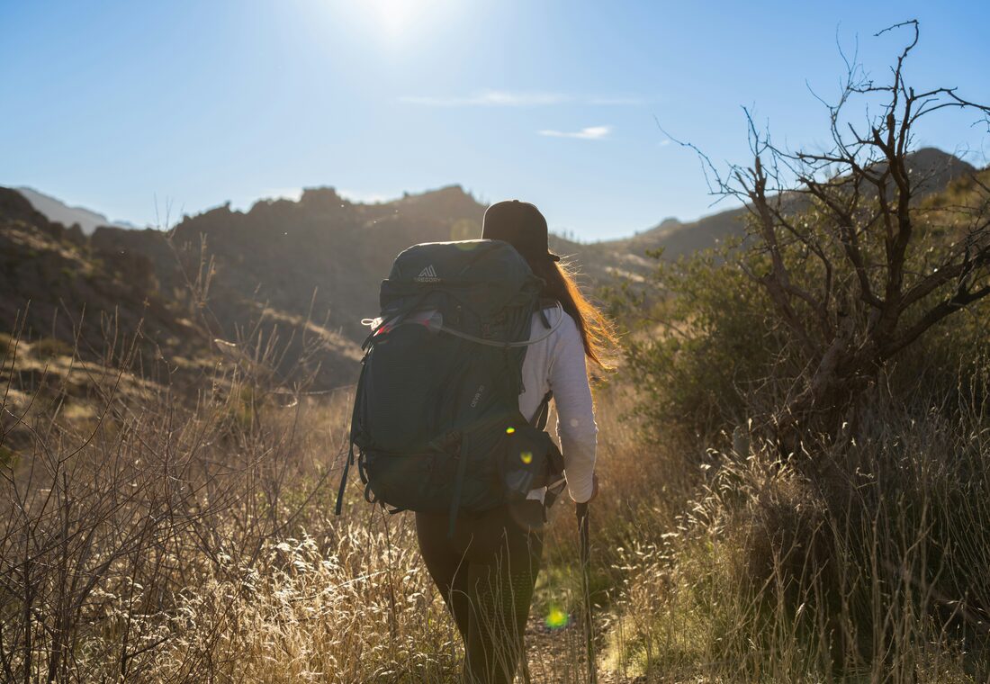 A traveler carrying a backpack outdoors